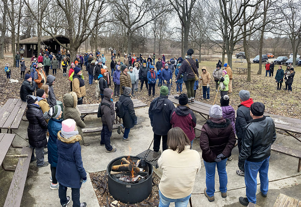 DNR educator Emily Cole addresses the hundred people gathered for the First Day Hike.