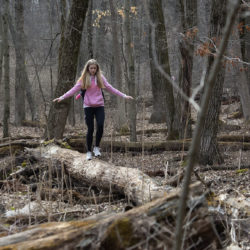 A girl walking on a log