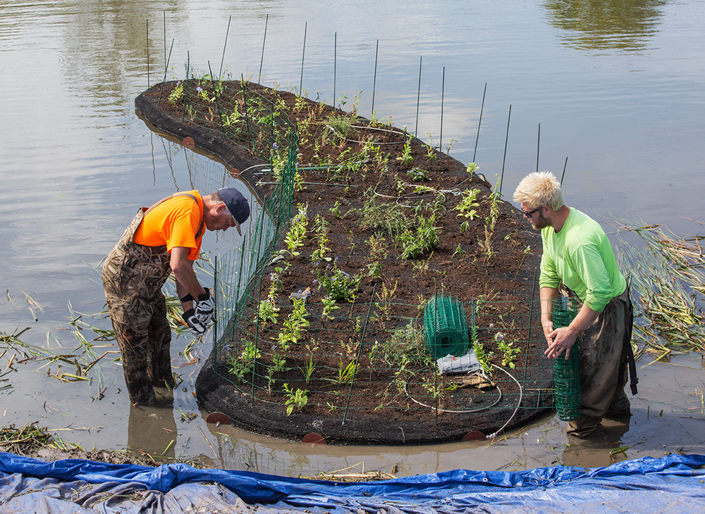 Workers prepare one of the islands for launching.