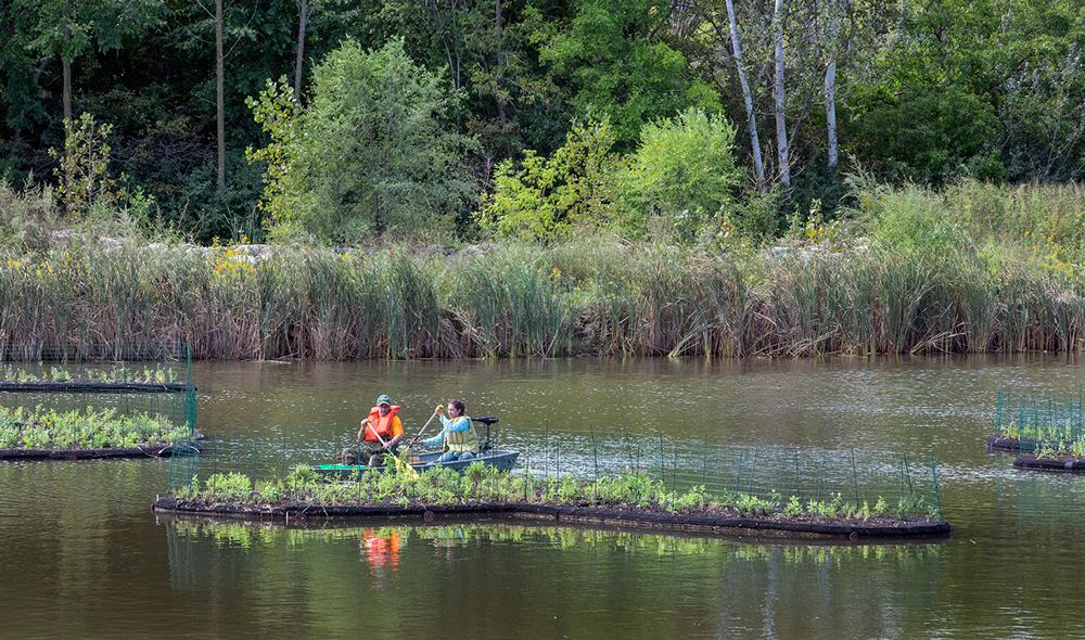 Workers attaching concrete anchors to an island.