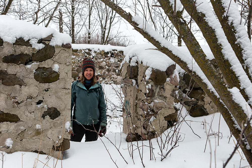 Cynthia Lorenz in stone foundation at the preserve. 