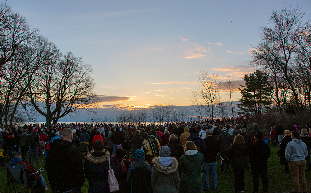 Hundreds of people gathered on bluff overlooking Lake Michigan