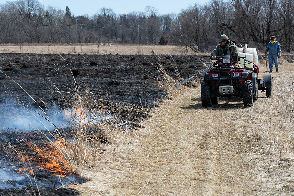 Ryan Wallin, OWLT Stewardship Director, spraying water