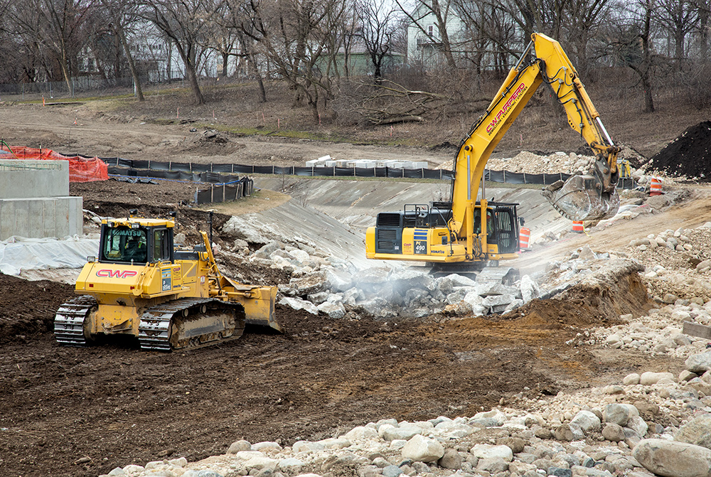 vehicles working in dry riverbed