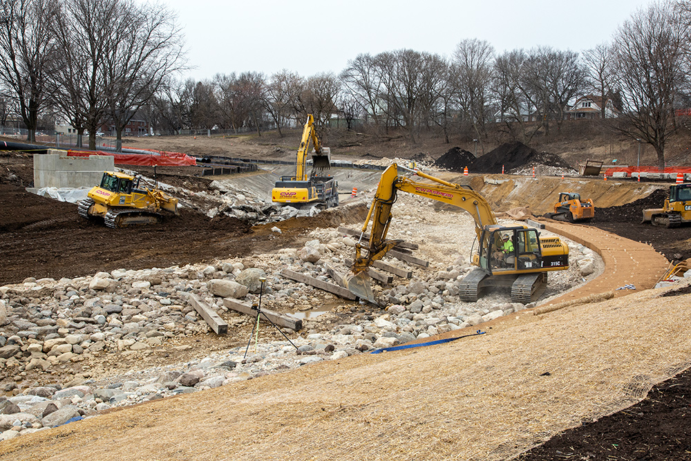 vehicles working in dry riverbed