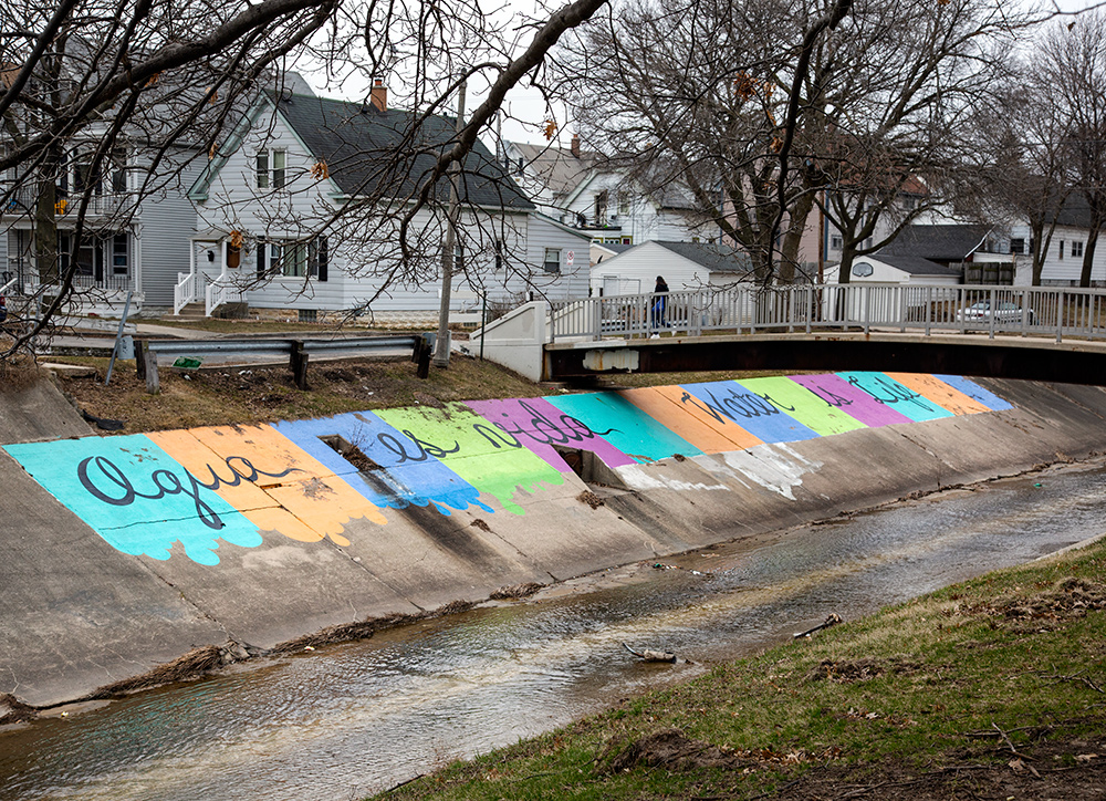 Aqua es Vida / Water is Life painted on concrete channel of river