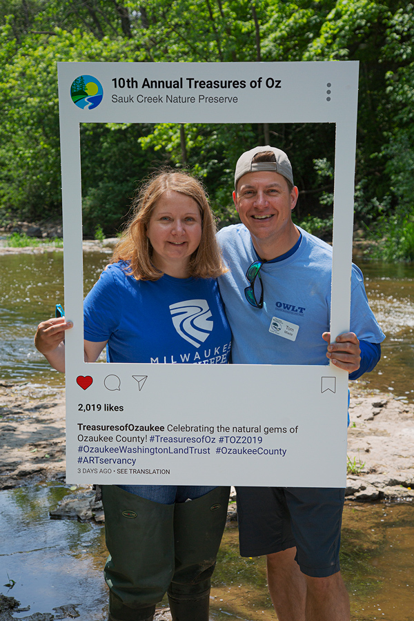 Cheryl Nenn, Milwaukee Riverkeeper, and Tom Mlada posing in Instagram frame next to Sauk Creek