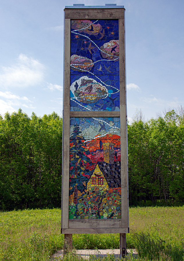 One side of swift tower showing colorful tile mural