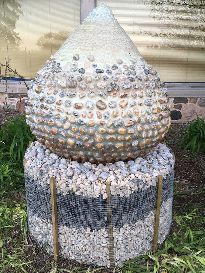 Tear-drop shaped culpture created with over 2,000 rocks harvested from the shores of Lake Michigan