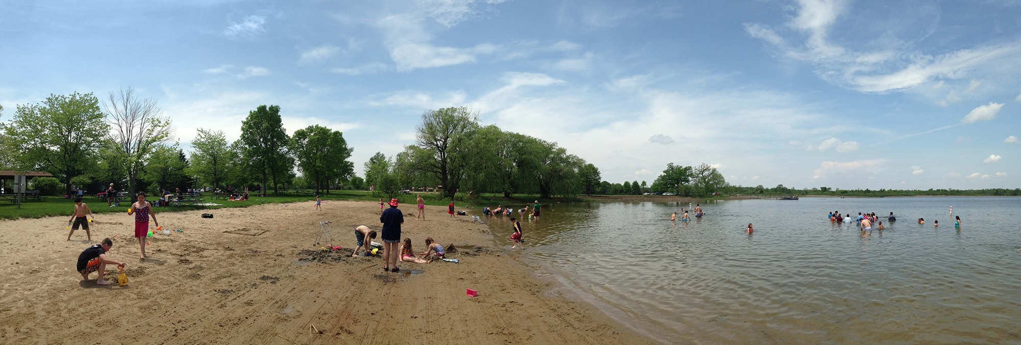 Ottawa Lake beach with people swimming in the water