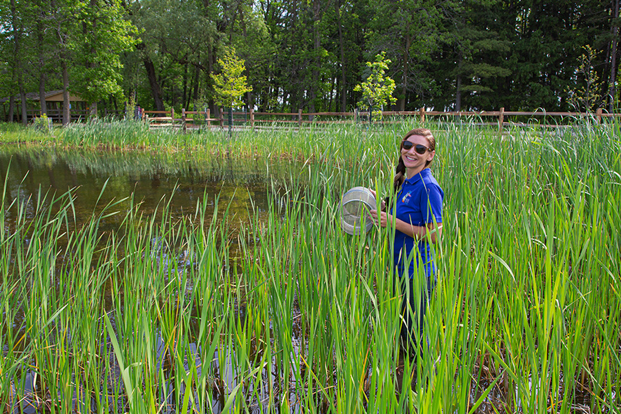 young woman in wetland with trap