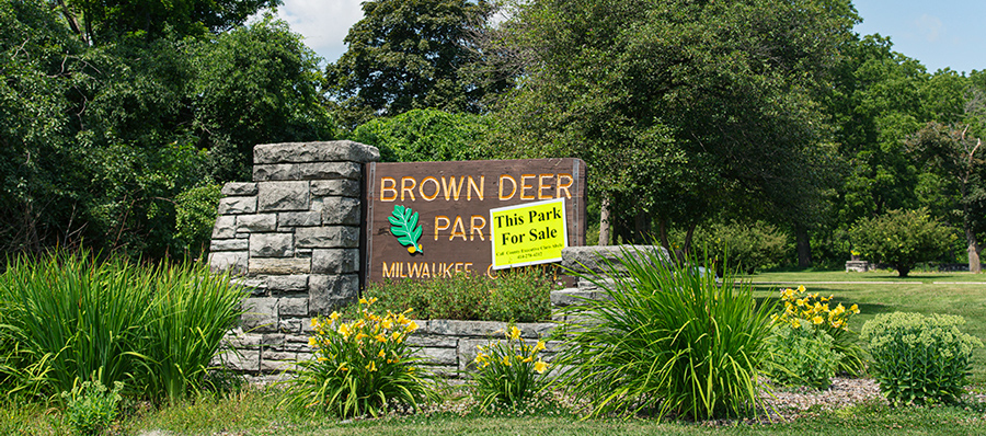 Brown Deer Park sign with a "This Park For Sale" sign attached