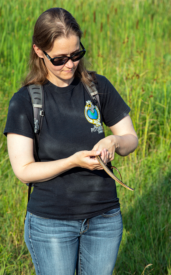 Citizen scientist Catherine holds a Butler's garter snake.