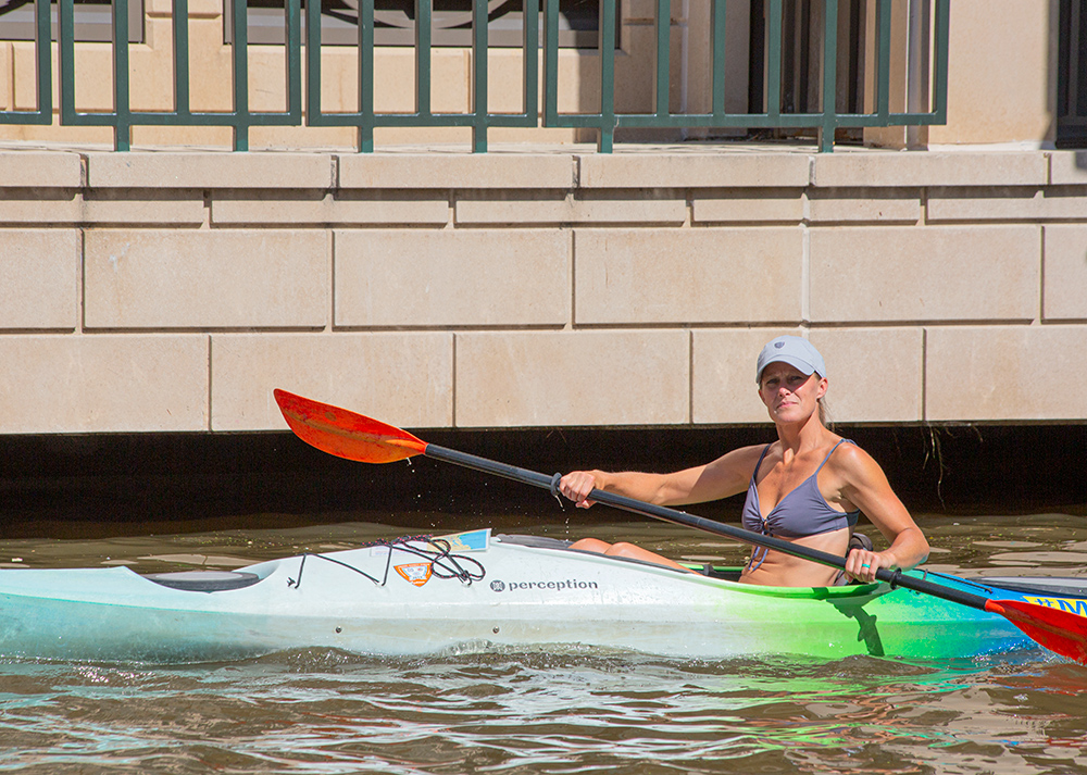 a female kayaker paddling 