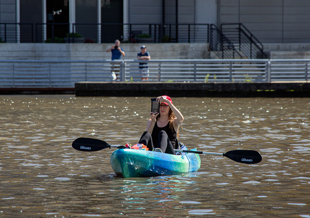 a young woman in a kayak taking a selfie