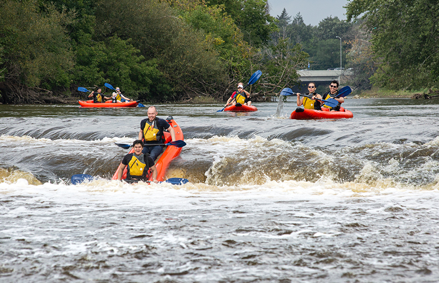 four rafts approaching falls on the Milwaukee River