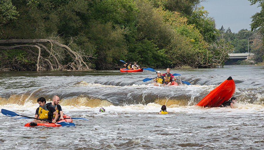 one of four red rafts capsized at the falls on the Milwaukee River