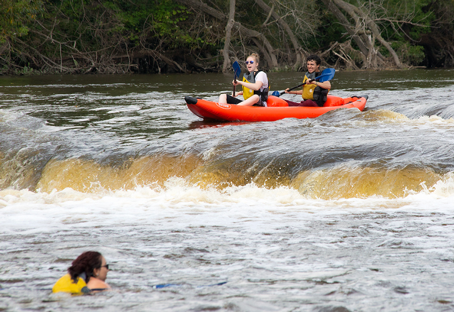 a raft going over the falls on the Milwaukee River 