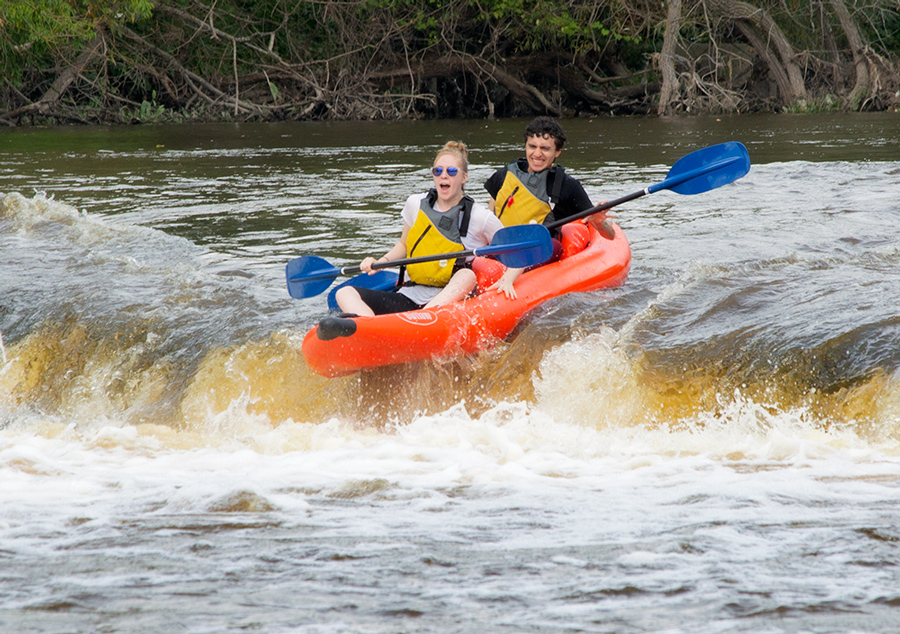 a raft going over the falls on the Milwaukee River 