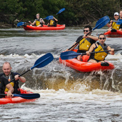 four rafts going over falls on the Milwaukee RIver