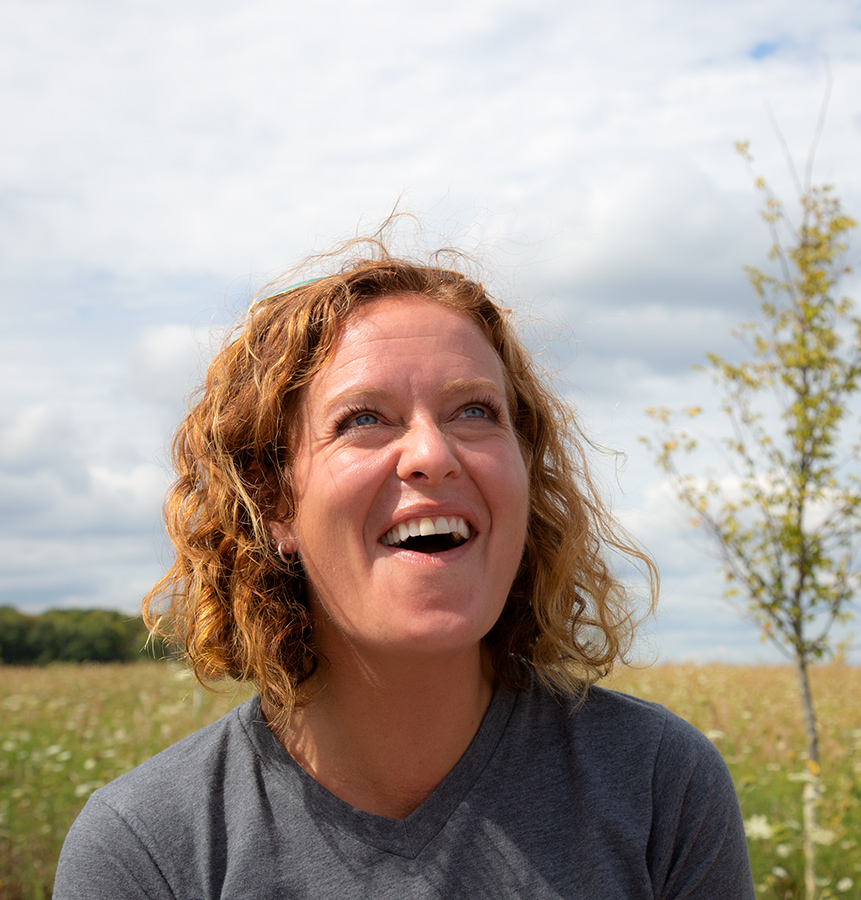 a woman watches with delight as a butterfly is released