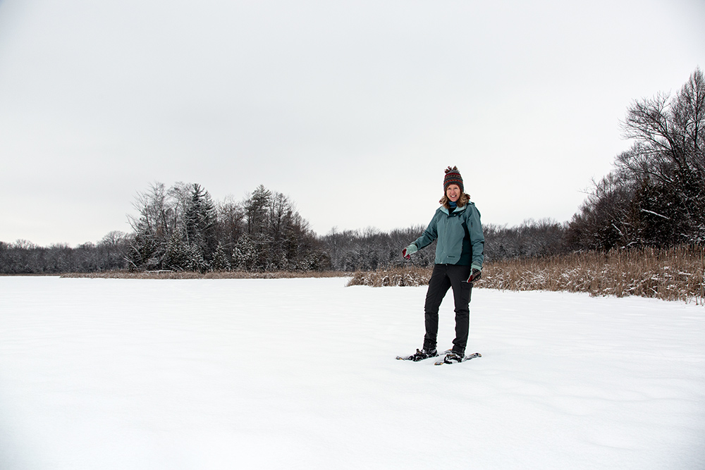 a woman snowshoeing on a frozen lake