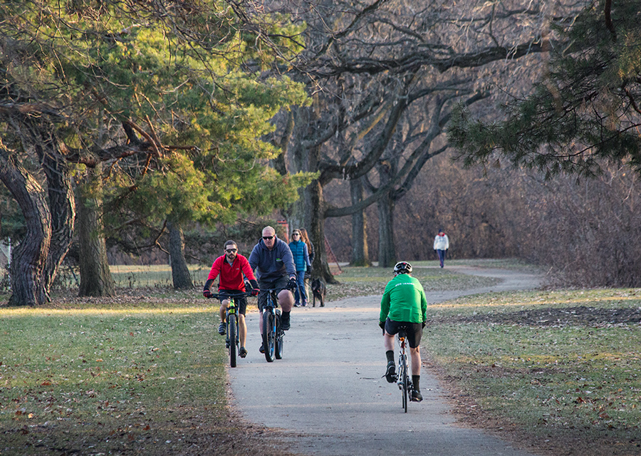 Several people walking and riding bicycles on the Oak Leaf Trail