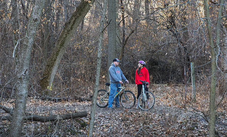 two cyclists on a woodland trail