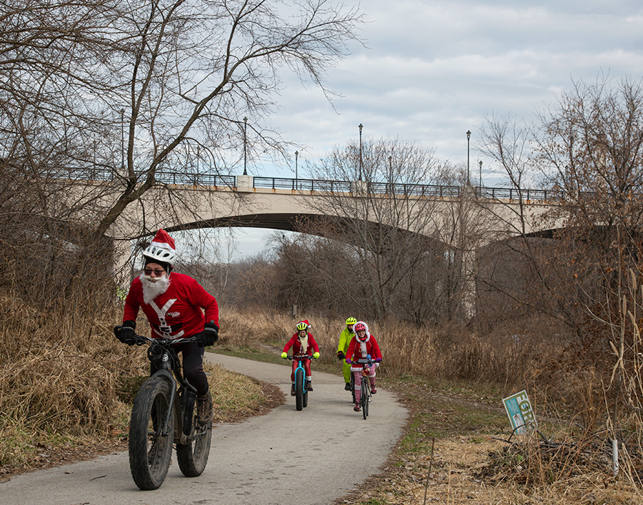 Santa Rampage cyclists on the Beerline Trail in the Milwaukee River Greenway