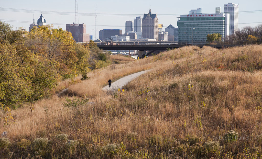 The Hank Aaron State Trail in Three Bridges Park with Milwaukee skyline