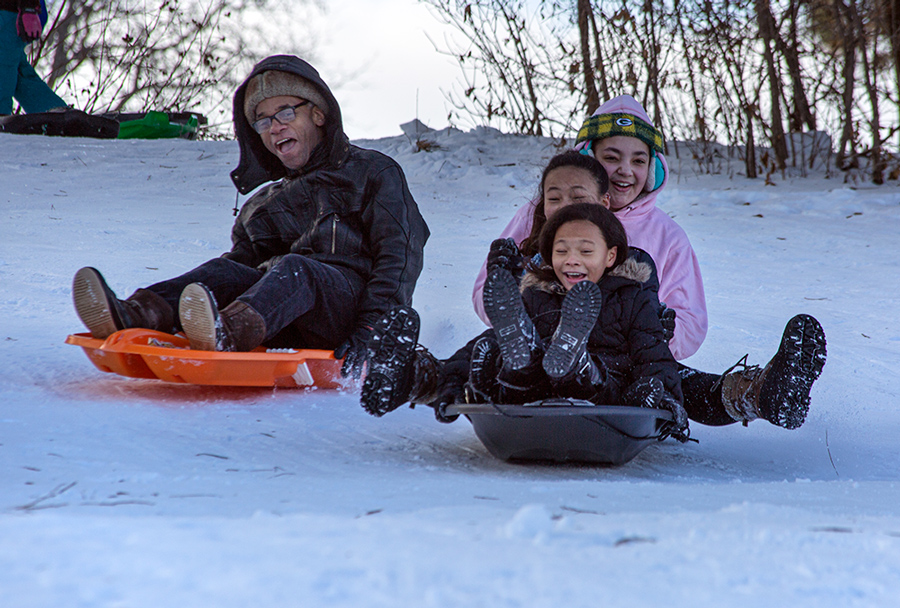 kids sledding with excitement