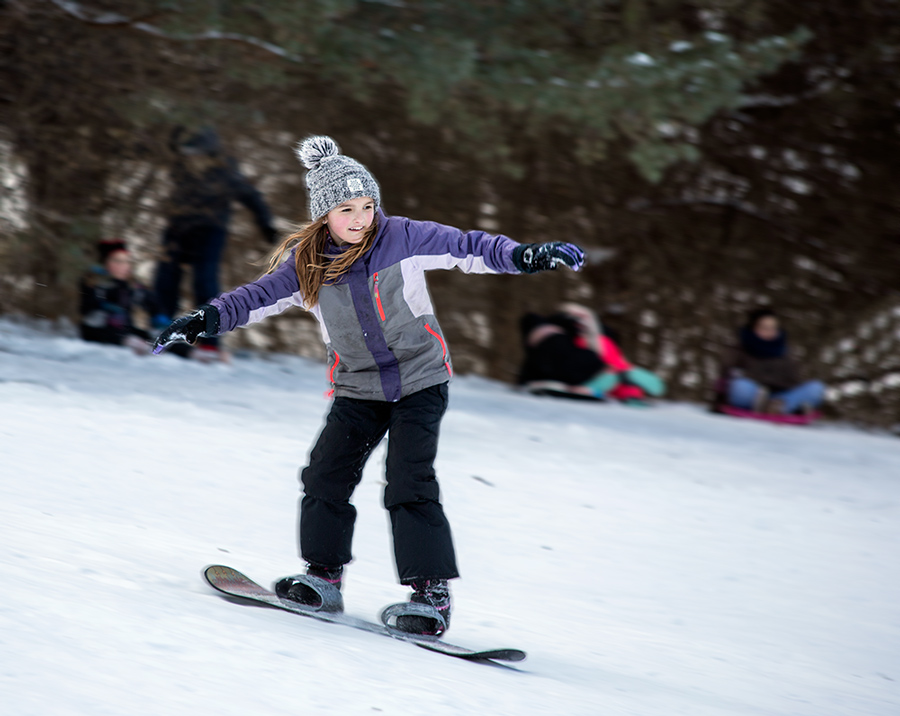 young girl on snowboard