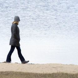 Mother and daughter walking on the beach at Pike Lake