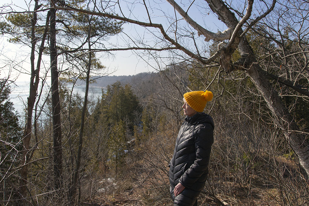 A woman overlooking Lake Michigan from a bluff top at Donges Bay Gorge Natural Area