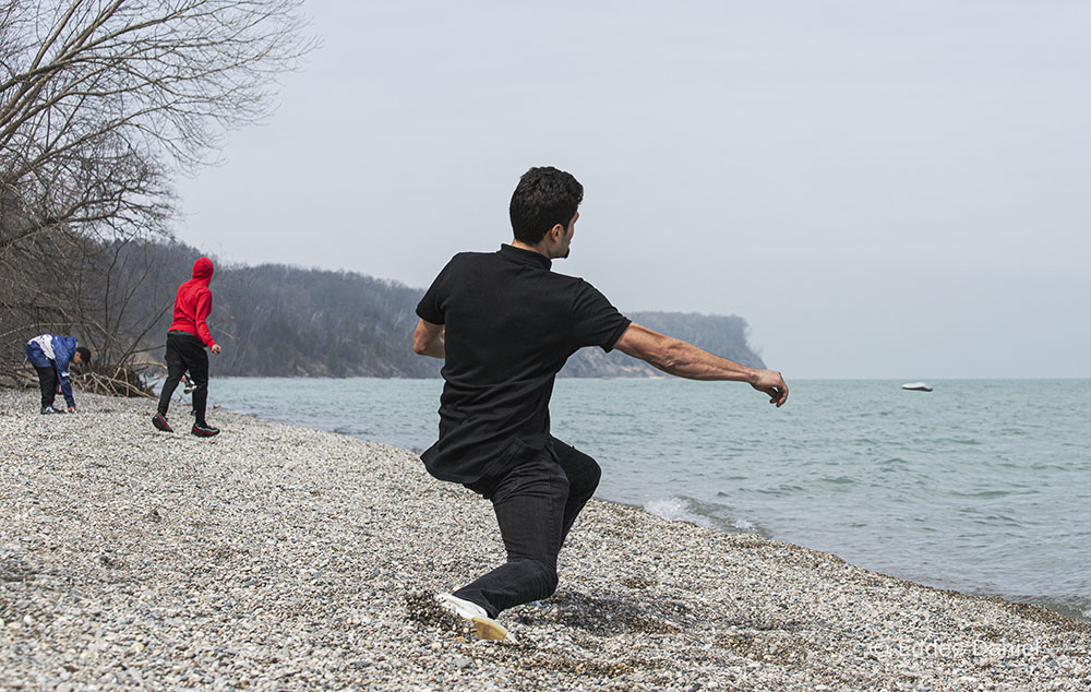 A young man skipping a stone on Lake Michigan at Grant Park, South Milwaukee