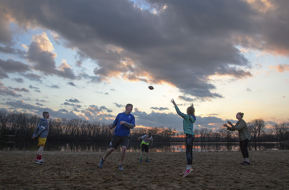 The Nellis family playing beach football at sunset, Fox Brook Park, Brookfield.