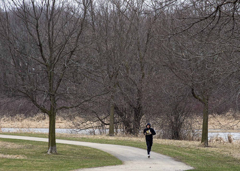 A lone jogger sprints along the Fox River Parkway in Waukesha.