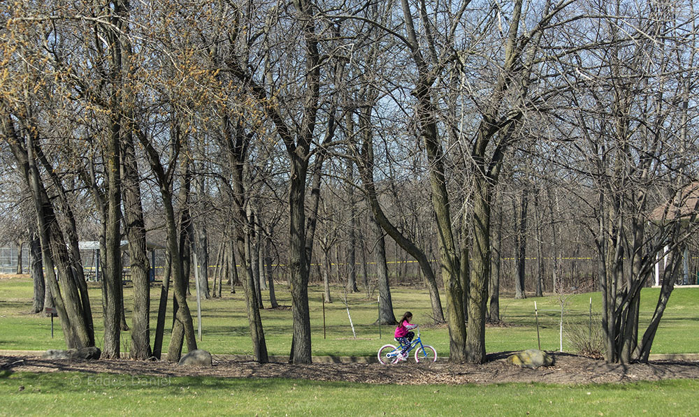 This little girl was just learning to ride with help from grandfather, Malone Park, New Berlin.