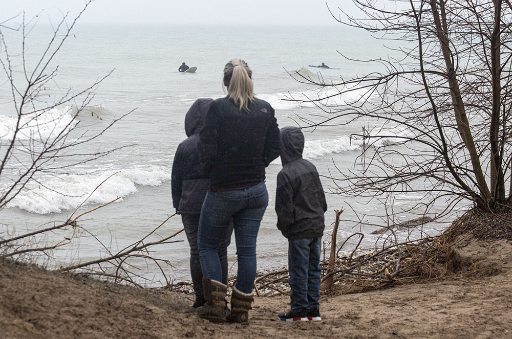 Driving rain did not keep surfers - or gawkers - away from the lake at Bradford Beach in Milwaukee.