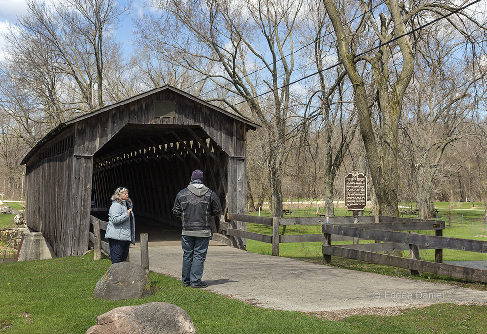 Social distancing of strangers at historic bridge. Covered Bridge Park, Cedarburg