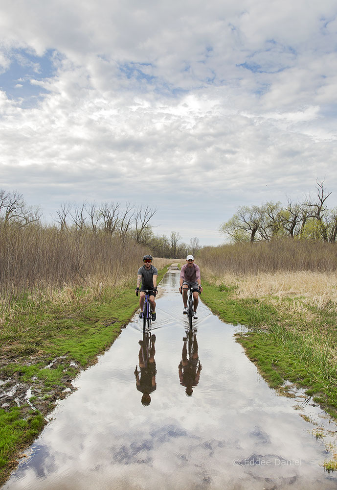 two cyclists on a flooded Oak Leaf Trail, Root River Parkway, Greenfield