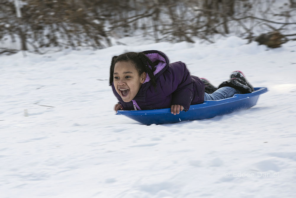 A youngster sledding at Curry Park, Wauwatosa.