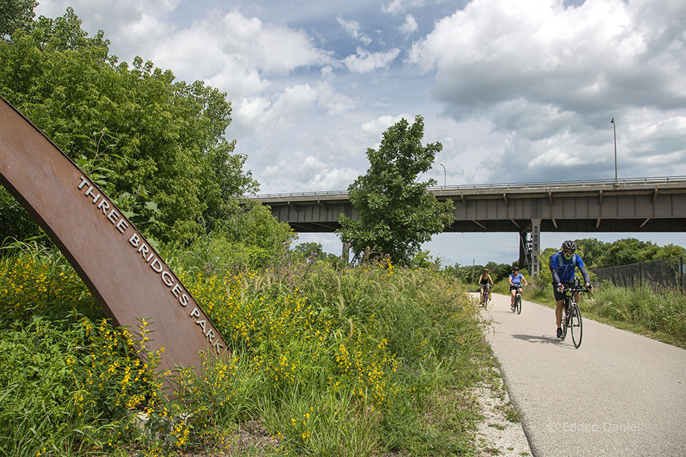 Three cyclists on the Hank Aaron State Trail in Three Bridges Park