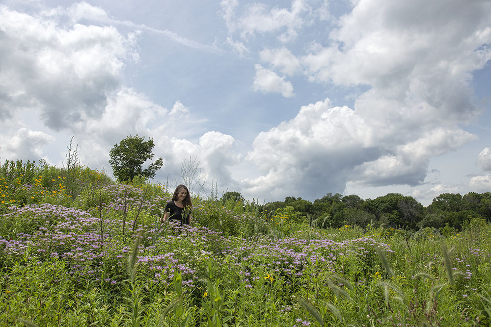 Kim Forbeck, Urban Ecology Center Manager of Land Stewardship, on a glorious summer day in the Rotary Centennial Arboretum.