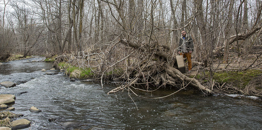 The artist with canvas next to Sauk Creek