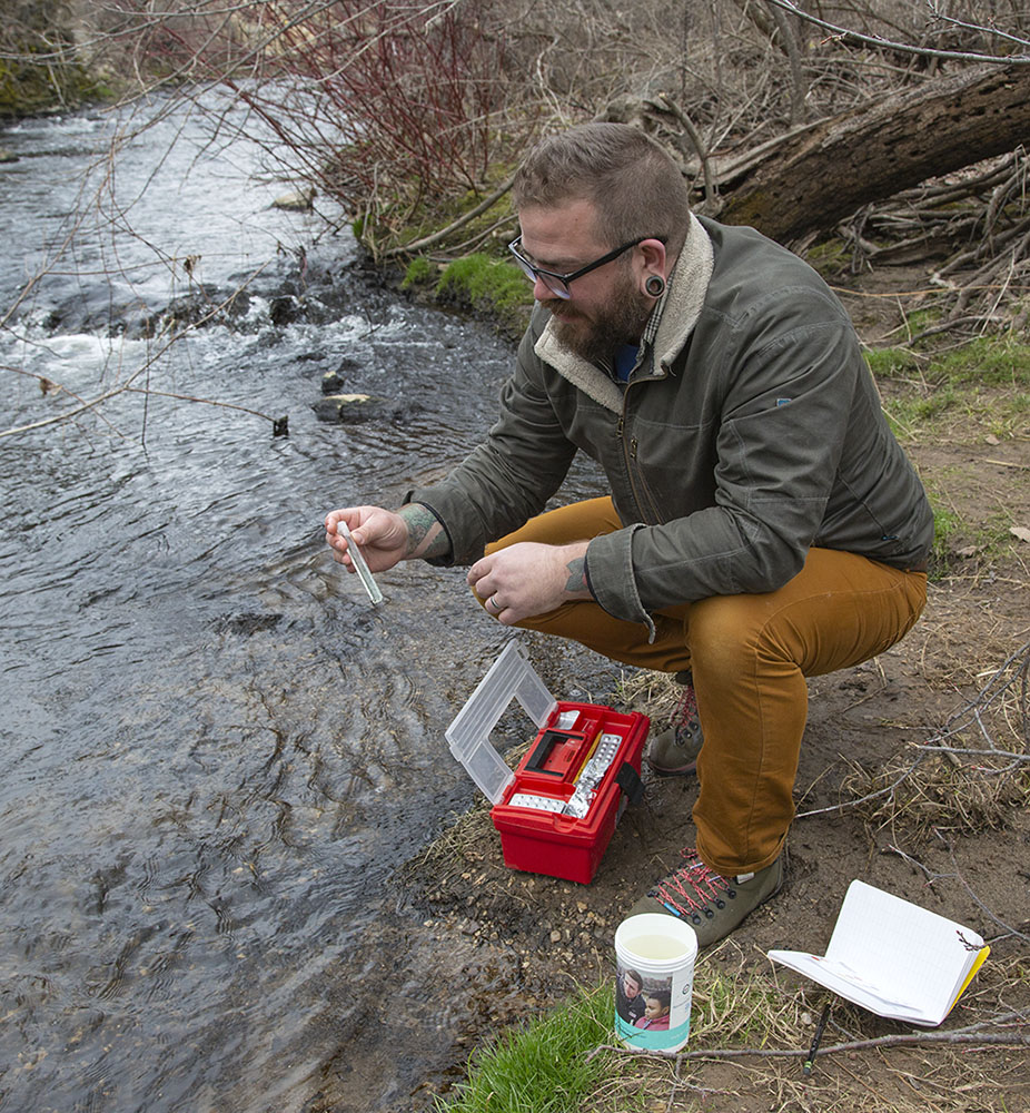 Devon testing the creek water for phosphorus