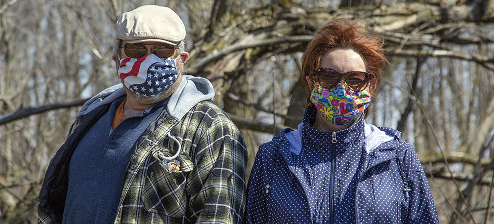 a man and woman wearing masks