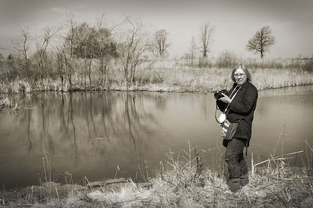 Vicki Reed overlooking a pond at Forest Beach