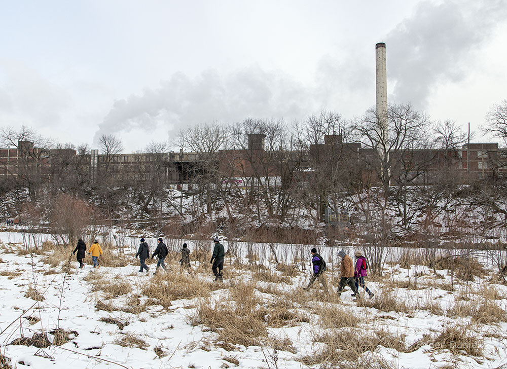 Meetup hikers on the West Bank Trail in view of Wisconsin Paperboard, a recycling plant