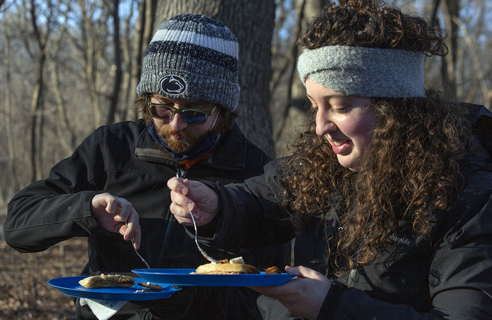 Digging in to campfire-grilled pancakes and home-made (by the UEC) syrup at Riverside Park